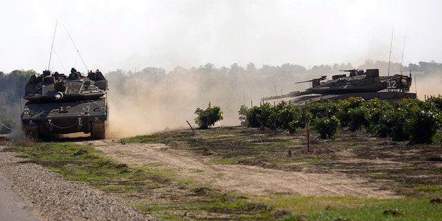 Israeli tanks move near the Israel Gaza border on Tuesday.