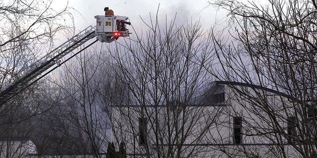 Authorities say two adults and two children were found dead at the scene of a burning mansion near the New Jersey shore.