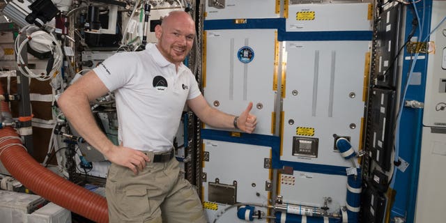 ESA astronaut Alexander Gerst poses on Oct. 19, 2018, with the ACLS life-support rack, newly installed on the International Space Station.