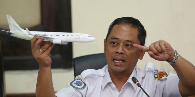 National Transportation Safety Committee investigator Nurcahyo Utomo holds a model of an airplane during a press conference on the committee's preliminary findings on their investigation on the crash of Lion Air flight 610, in Jakarta, Indonesia, Wednesday, Nov. 28, 2018.