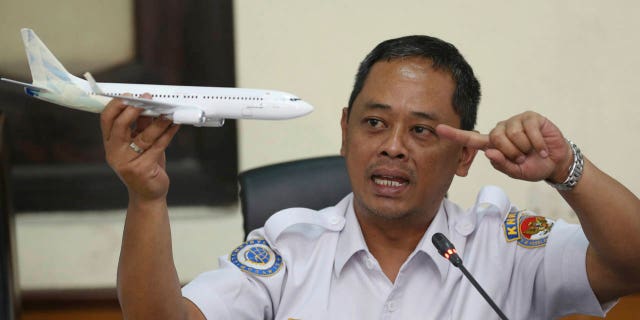 National Transportation Safety Committee investigator Nurcahyo Utomo holds a model of an airplane during a press conference on the committee's preliminary findings on their investigation on the crash of Lion Air flight 610, in Jakarta, Indonesia, Wednesday, Nov. 28, 2018.