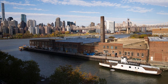 A rusting ferryboat is docked next to an aging industrial warehouse on the Anable Basin, in the Long Island City neighborhood of the Queens borough of New York. Amazon announced Tuesday that this area will house one of its newest headquarters.