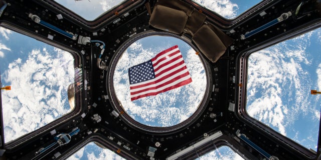 An American flag floats in weightlessness, with the Earth as a magnificent backdrop, in this photo from the Cupola observation room on the International Space Station taken by NASA astronaut Kjell Lindgren.