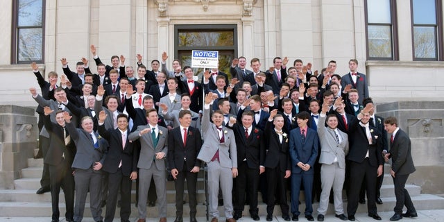 A group of Wisconsin high school students standing on the steps in front of the Sauk County Courthouse in Baraboo, Wisconsin.