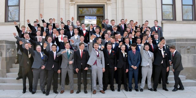 A group of Wisconsin high school boys stand on the steps outside the Sauk County Courthouse in Baraboo, Wisconsin.