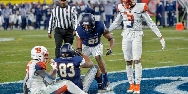 Notre Dame wide receiver Chase Claypool is congratulated after scoring a touchdown during an NCAA college football game against Syracuse.
