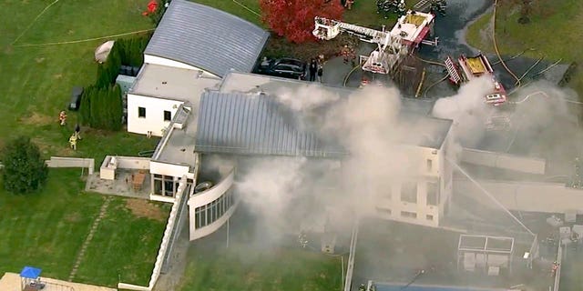 In this image made from a video provided by WABC firefighters battle a fatal fire on Tuesday, Nov. 20, 2018, in Colts Neck, N.J.