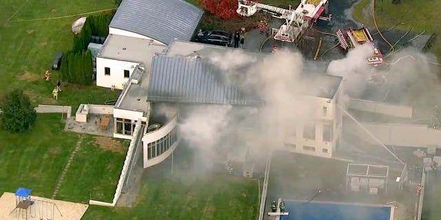 In this image made from a video provided by WABC firefighters battle a fatal fire on Tuesday, Nov. 20, 2018, in Colts Neck, N.J.