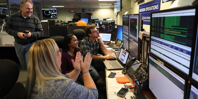 Members of the Parker Solar Probe mission team celebrate on Nov. 7, 2018, after receiving a beacon indicating the spacecraft is in good health following its first perihelion. (Credit: NASA/Johns Hopkins APL/Ed Whitman)