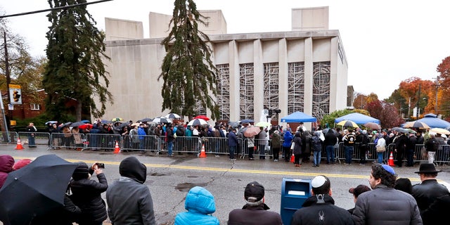 People line both sides of the street as they gather outside the Pittsburgh synagogue on Saturday.