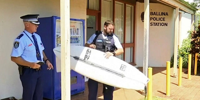 A man has used his surfboard to fend off a shark that bit him on his calf off an Australian beach two days after a fatal attack on the Great Barrier Reef.