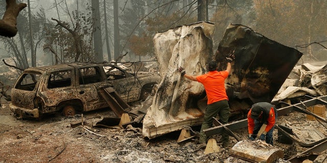 Search and rescue works search for human remains at a trailer park burned by the Camp Fire, Tuesday, Nov. 13, 2018.