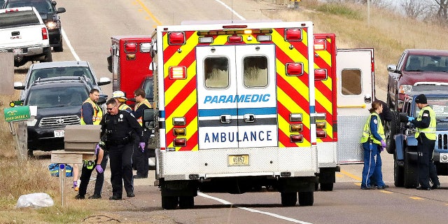 Emergency medical personnel gather at the scene of a hit-and-run accident Saturday, Nov. 3, 2018, in Lake Hallie, Wisconsin, that killed three girls and an adult. (Steve Kinderman/The Eau Claire Leader-Telegram via AP)
