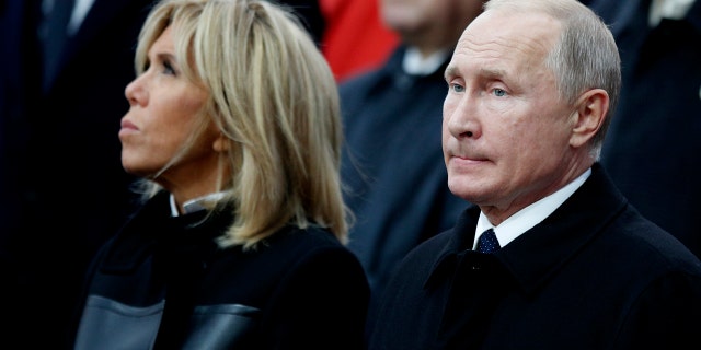 French President's Emmanuel Macron's wife Brigitte and Russian President Vladimir Putin attend ceremonies at the Arc de Triomphe Sunday, Nov. 11, 2018 in Paris.