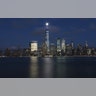 The moon rises behind the skyline of lower Manhattan and One World Trade Center in New York City, Nov. 20, 2018. 