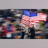 Fire and law enforcement first responders run with United States flags as they lead players out of the tunnel before an NFL football game between the Los Angeles Rams and the Kansas City Chiefs, in Los Angeles, Nov. 19, 2018. 