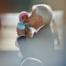Chile's President Sebastian Pinera kisses a baby as he receives a group of repatriates at the international airport in Santiago, Chile, Nov. 27, 2018. 