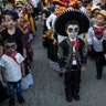 Children in costume gather for the start of a parade marking Day of the Dead in Juchitan, Mexico, Oct. 31, 2018.