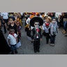 Children in costume gather for the start of a parade marking Day of the Dead in Juchitan, Mexico, Oct. 31, 2018.