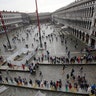 As rainstorms and strong winds batter Italy, tourists cross a flooded St. Mark's Square in Venice, Nov. 1, 2018.