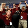 Engineers Kris Bruvold and Sandy Krasner celebrate at the Jet Propulsion Laboratory as the NASA InSight lander touches down on Mars, in Pasadena, Nov. 26, 2018.