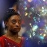 World champion Simone Biles of the United States waits for the medal ceremony after the women's team final at the Gymnastics World Championships in Doha, Qatar, Oct. 30, 2018.
