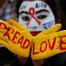 A student poses as she displays her face and hands painted with messages during an HIV/AIDS awareness campaign on the eve of World AIDS Day in Chandigarh, India, Nov. 30, 2018. 