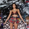 Kendall Jenner shows off a trendy plaid bra and underwear set accessorized with a high-waisted, belted kilt. 