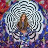 Josephine Skriver struts down the runway in neon-patterned pantaloons with a matching top and whimsical parachute. 