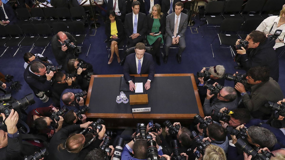 Facebook CEO Mark Zuckerberg takes his seat to testify before a joint hearing of the Commerce and Judiciary Committees on Capitol Hill in Washington, Tuesday, April 10, 2018, about the use of Facebook data to target American voters in the 2016 election. (AP Photo/Pablo Martinez Monsivais)