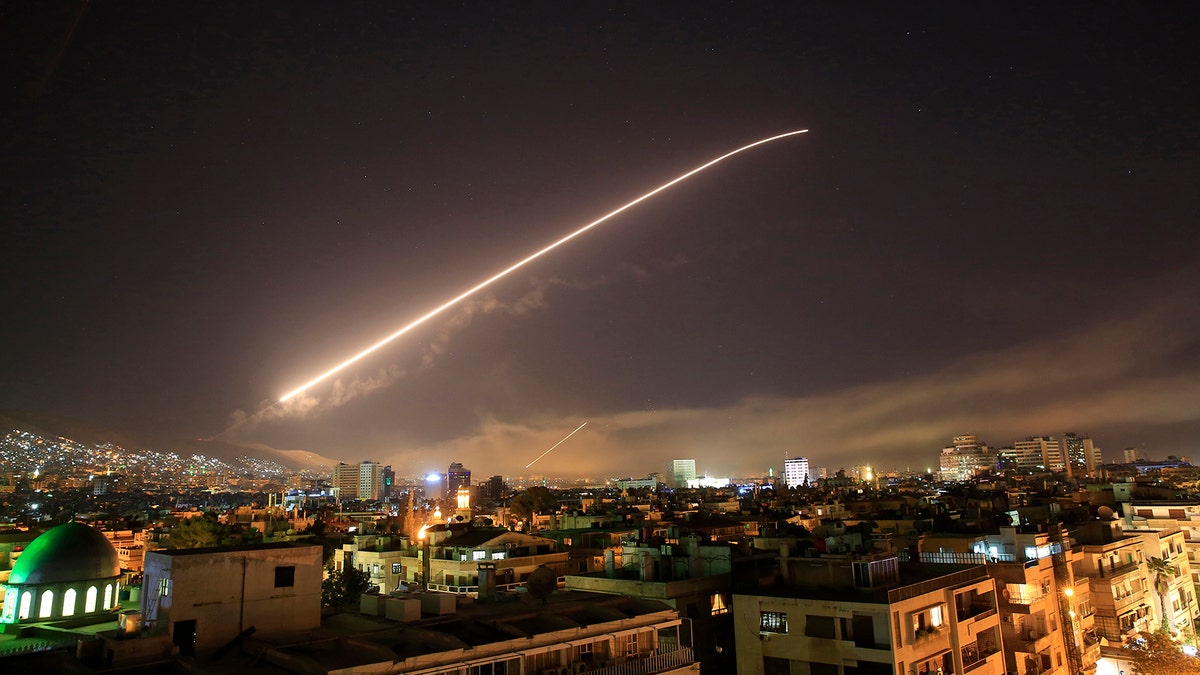 The Damascus sky lights up missile fire as the U.S. launches an attack on Syria targeting different parts of the capital early Saturday, April 14, 2018.  (AP Photo/Hassan Ammar)