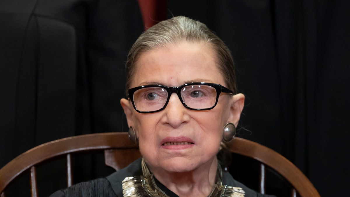 In this Nov. 30, 2018 file photo, Associate Justice Ruth Bader Ginsburg sits with fellow Supreme Court justices for a group portrait at the Supreme Court Building in Washington. (AP Photo/J. Scott Applewhite)
