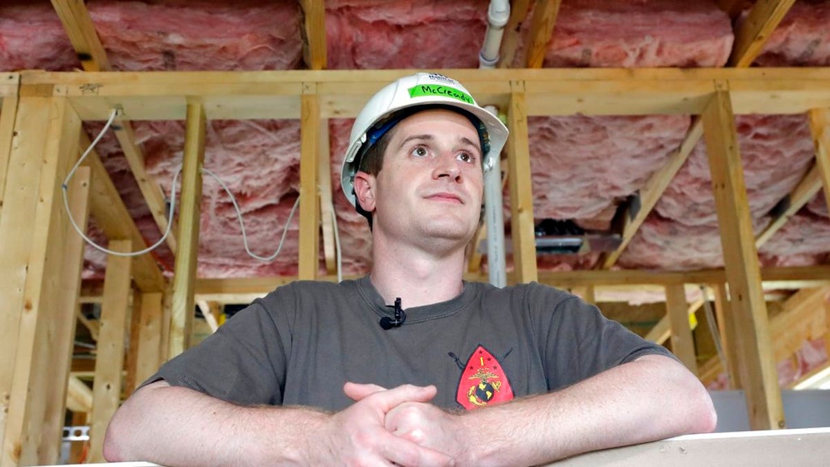 FILE - In this Sept. 26, 2018, file photo, Democratic congressional candidate Dan McCready leans against wallboard as he pauses during a Habitat For Humanity building event in Charlotte, N.C. (AP Photo/Chuck Burton, File)