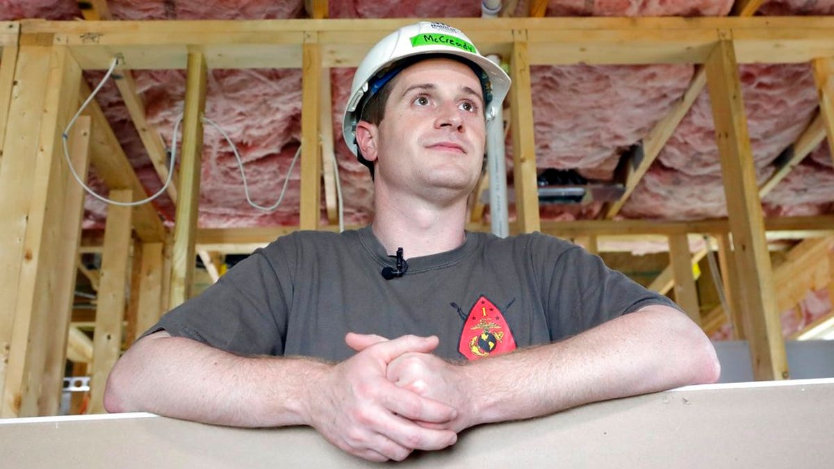 FILE - In this Sept. 26, 2018, file photo, Democratic congressional candidate Dan McCready leans against wallboard as he pauses during a Habitat For Humanity building event in Charlotte, N.C. The nation's last unresolved fall congressional race with McCready against Republican Mark Harris is awash in doubt as North Carolina election investigators concentrate on a rural county where absentee-ballot fraud allegations are so flagrant they've put the Election Day result into question. (AP Photo/Chuck Burton, File)