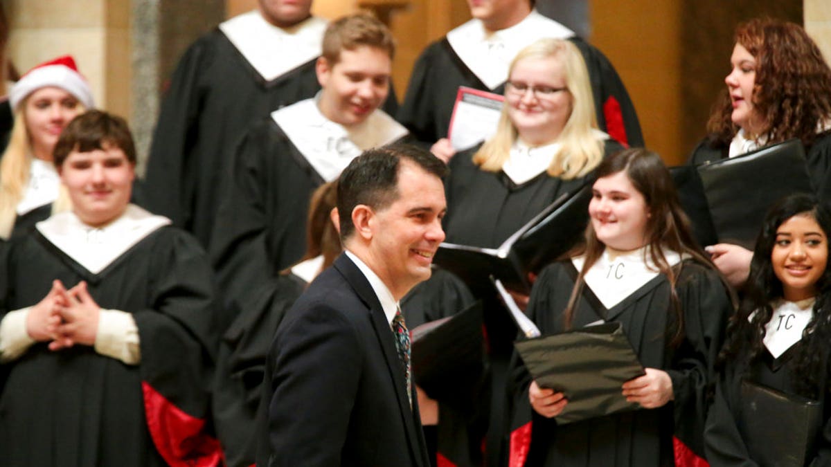 Wisconsin Gov. Scott Walker arrives for the lighting of the state Christmas Tree in the Capitol Rotunda, Tuesday, Dec. 4, 2018 at the Capitol in Madison, Wis. The Senate and Assembly are set to send dozens of changes in state law to Walker's desk Tuesday. (Steve Apps/Wisconsin State Journal via AP)