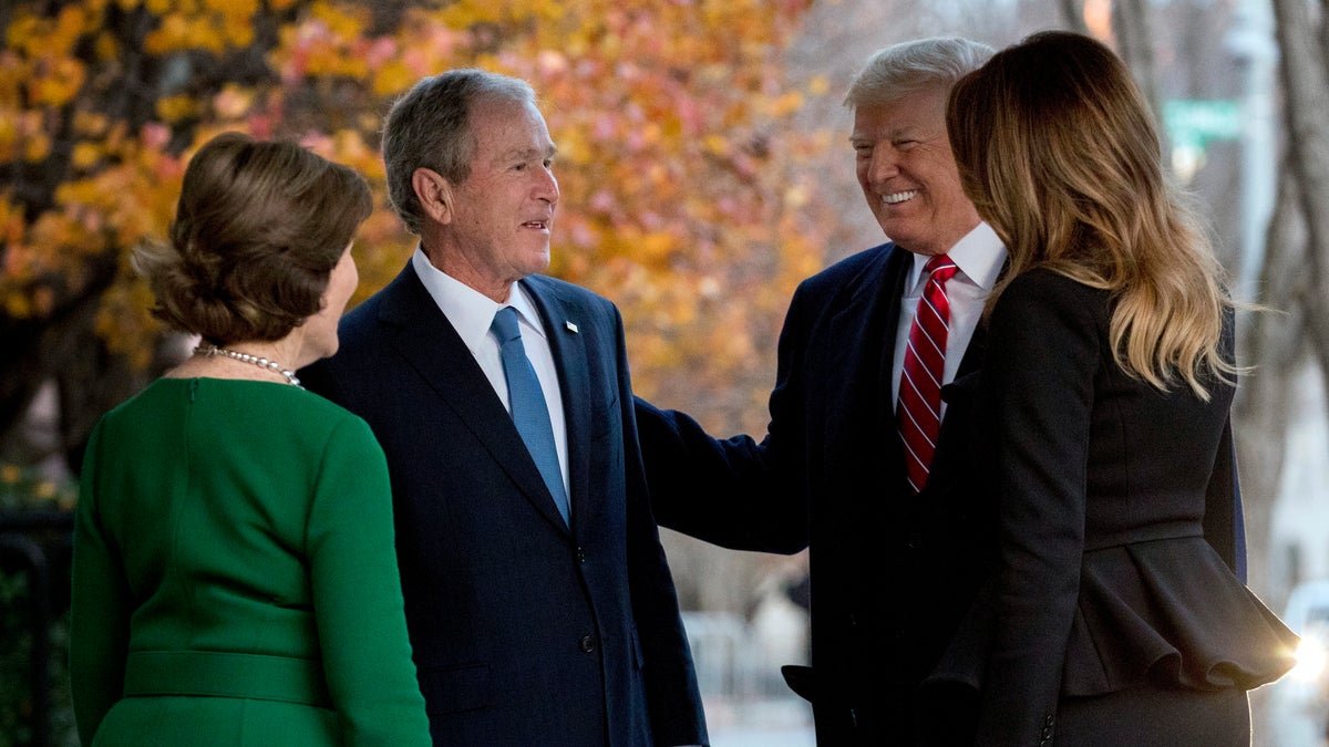 President Donald Trump and first lady Melania Trump are greeted by former President George W. Bush and former first lady Laura Bush outside the Blair House.