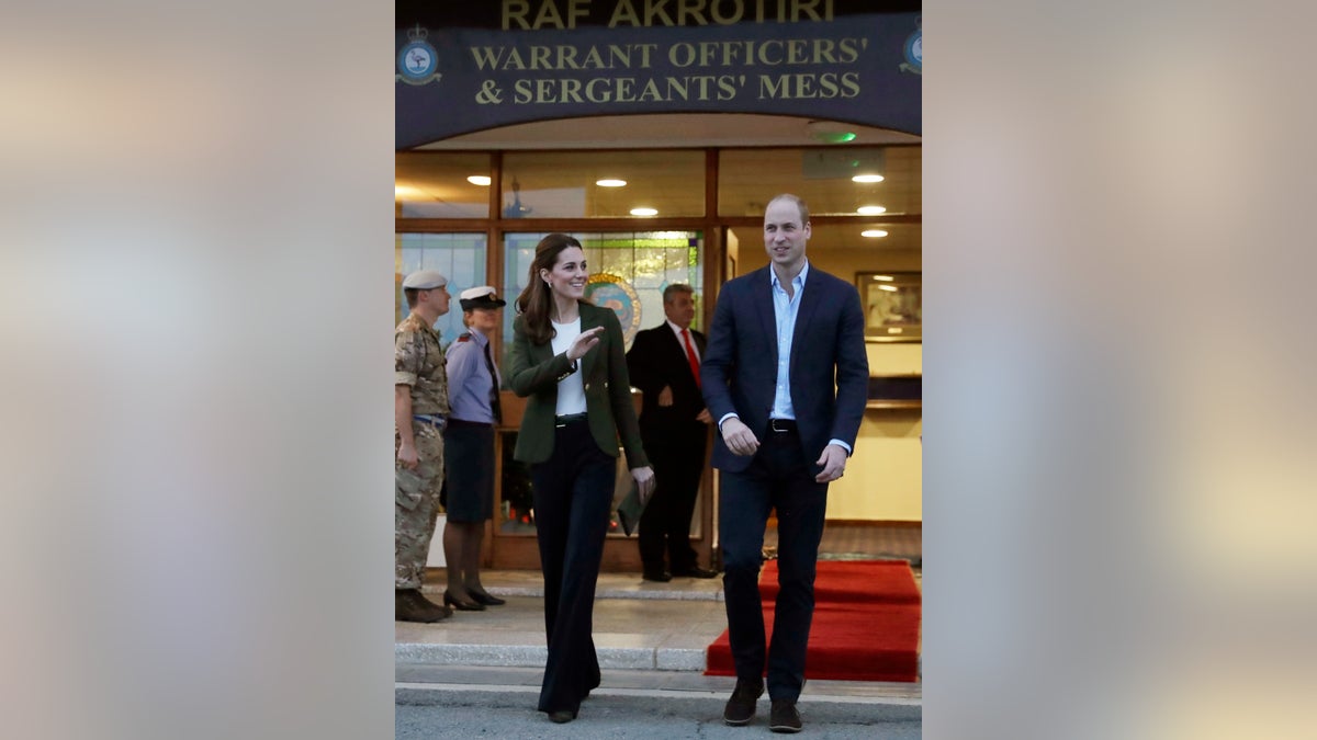 Britain's Prince William, right, and his wife Kate, the Duchess of Cambridge, stand outside the mess hall at the Akrotiri Royal Air Force base, near the south coastal city of Limassol, Cyprus, Wednesday, Dec. 5, 2018. 
