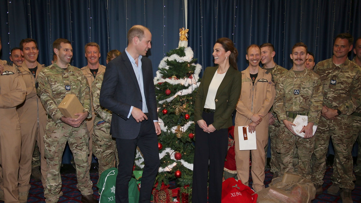 Prince William and Kate Duchess of Cambridge pose with Service Personnel during a Christmas party on RAF Akrotiri in Cyprus, as the Royal couple visit the Sergent's mess to hand out gifts Wednesday Dec. 5, 2018. The RAF Akrotiri is the home of the Cyprus Operations Support Unit which supplies support to operations in the region to protect the UK's strategic interests. 