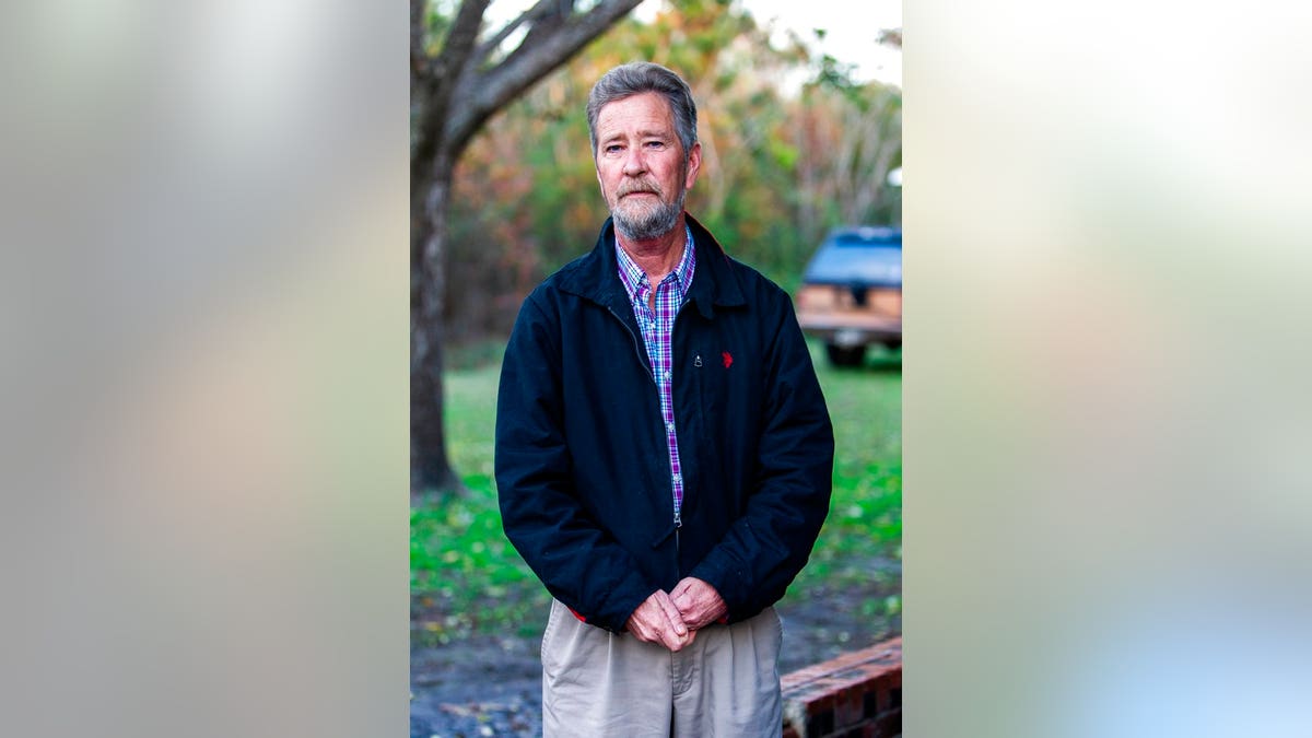 In this Wednesday, Dec. 5, 2018 photo, Leslie McCrae Dowless poses for a portrait outside of his home in Bladenboro, N. C.  Focus has centered on Republican operative Dowless, who worked for Harris and returned almost half of absentee ballot requests in a single county last month. Harris had been convicted of insurance fraud in 1992.(Travis Long/The News &amp; Observer via AP)