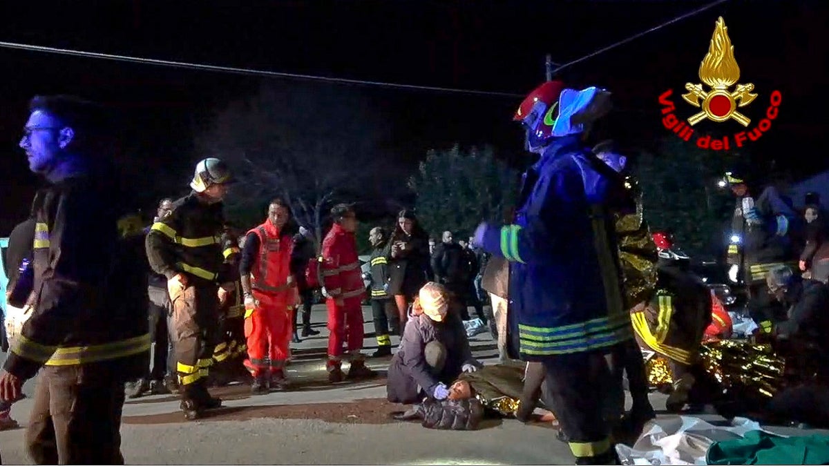 In this frame taken from video rescuers assist injured people outside a nightclub in Corinaldo, central Italy, early Saturday, Dec. 8, 2018. 