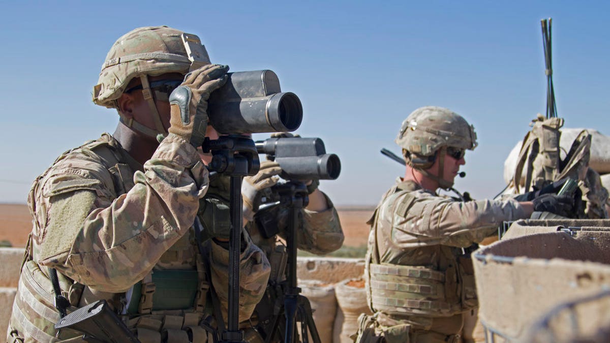 US Army forces in camouflage uniforms with special camera equipment on patrol in Syria