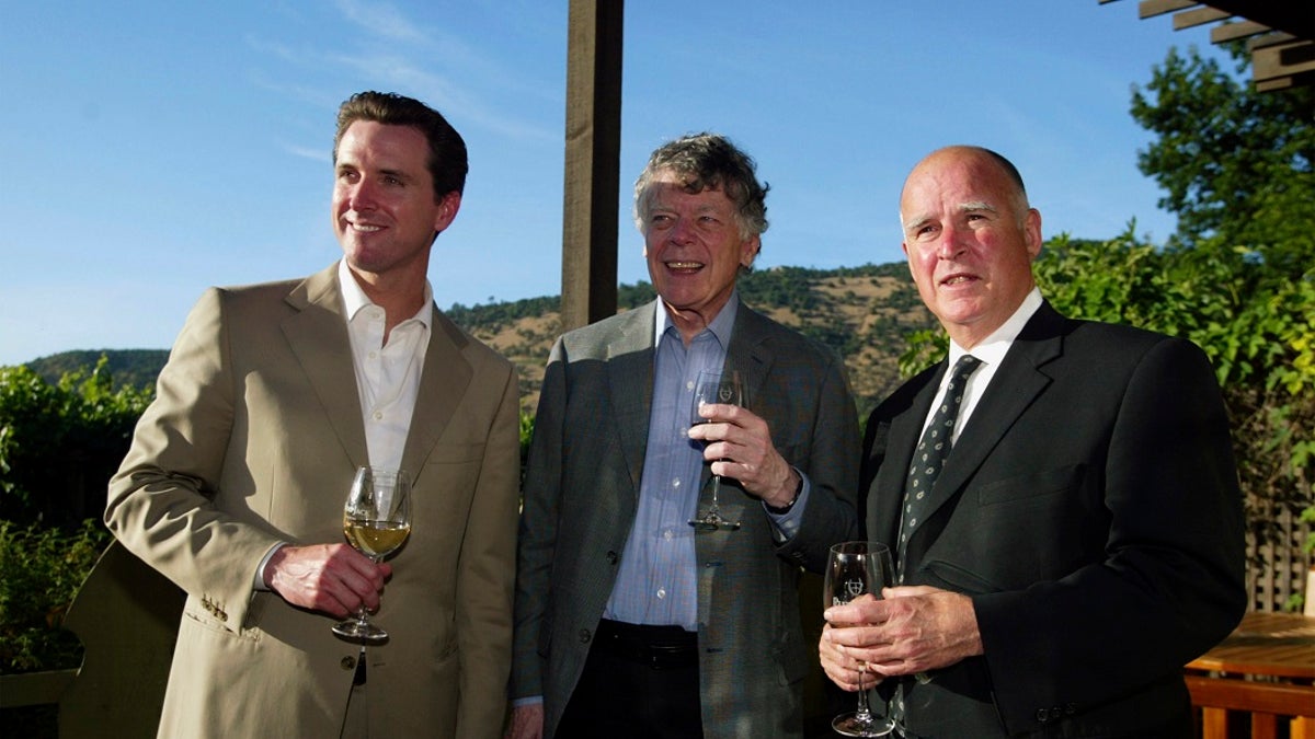 FILE - In this June 3, 2004, file photo, San Francisco Mayor Gavin Newsom, from left, Gordon Getty and Oakland Mayor Jerry Brown enjoy a pre-dinner glass of wine during a hospitality event of the Napa Valley Wine Auction at the PlumpJack Winery in Oakville, Calif. (Associated Press)