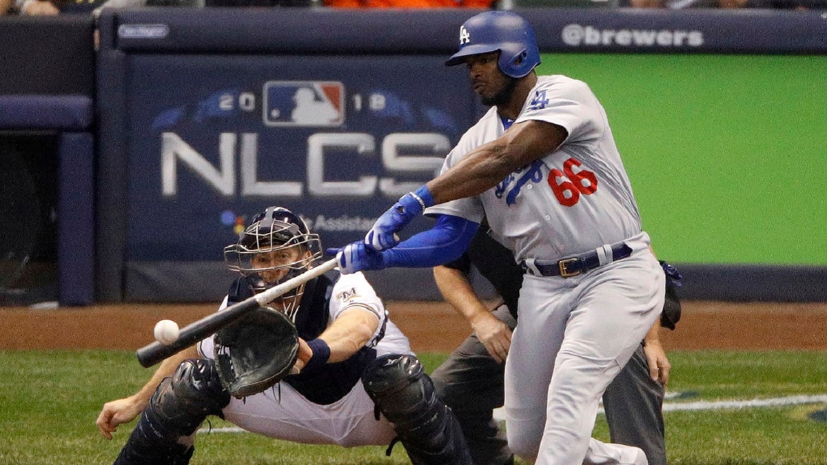 FILE: Los Angeles Dodgers' Yasiel Puig (66) hits a three -run home run during the sixth inning of Game 7 of the National League Championship Series baseball game against the Milwaukee Brewers in Milwaukee, Oct. 20, 2018.