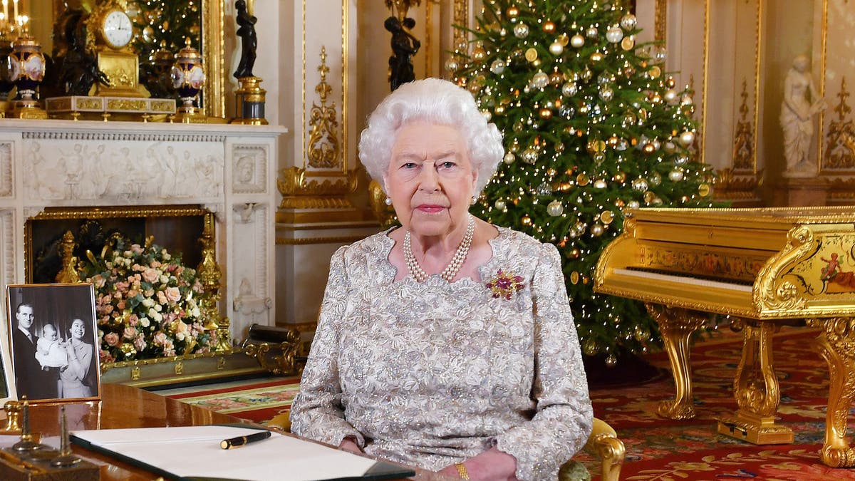 In this photo released on Monday, Dec. 24, 2018, Queen Elizabeth II poses after she recorded her annual Christmas Day message, in the White Drawing Room of Buckingham Palace in central London.