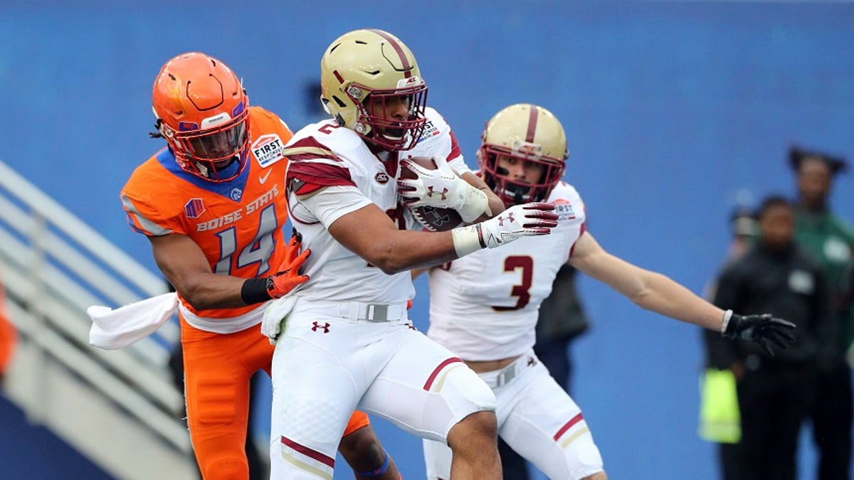 Boston College running back AJ Dillon (2) scores a touchdown ahead of Boise State cornerback Tyler Horton (14) during the first half of the First Responder Bowl NCAA football game Wednesday, Dec. 26, 2018, in Dallas. But the score won't count because the game was later canceled. (Associated Press)