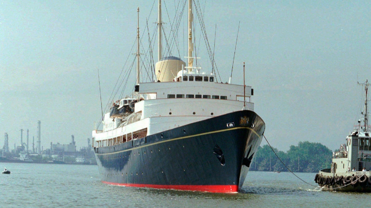 FILE - In this Friday, May 9, 1997 file photo, a long-tailed boat passes by the British Royal Yacht Britannia as it is tugged to port in Bangkok. A newly discovered note dated 1995 in the U.K.’s National Archives Saturday Dec. 29, 2018, shows that Queen Elizabeth II let government officials know she would welcome a replacement for the Royal Yacht Britannia once it was decommissioned. The Royal Yacht Britannia was in service from 1954 to 1997. (AP Photo/Charles Dharapak, file)