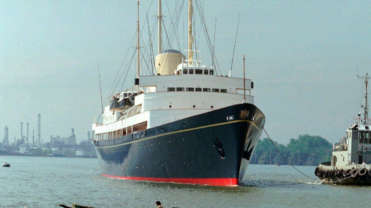 FILE - In this Friday, May 9, 1997 file photo, a long-tailed boat passes by the British Royal Yacht Britannia as it is tugged to port in Bangkok. A newly discovered note dated 1995 in the U.K.’s National Archives Saturday Dec. 29, 2018, shows that Queen Elizabeth II let government officials know she would welcome a replacement for the Royal Yacht Britannia once it was decommissioned. The Royal Yacht Britannia was in service from 1954 to 1997. (AP Photo/Charles Dharapak, file)