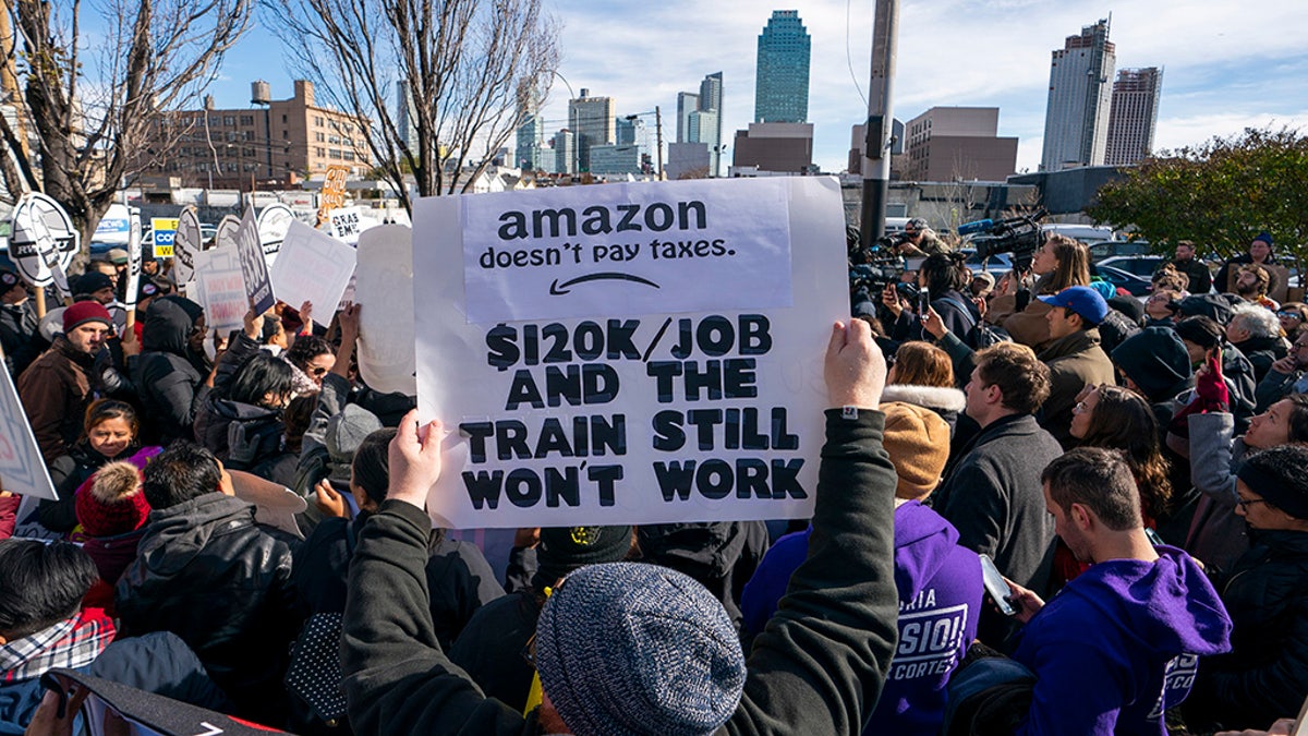 Protesters gather in Long Island City to say "No" to the Amazon "HQ2" decision on November 14, 2018 in Long Island City, New York. (Photo by Don EMMERT / AFP)