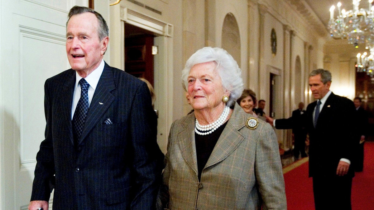 FILE - In this Jan. 7, 2009, file photo, former President George H. W. Bush, left, walks with his wife, former first lady Barbara Bush, followed by their son, President George W. Bush, and his wife first lady Laura Bush, to a reception in honor of the Points of Light Institute, in the East Room at the White House in Washington.  (AP Photo/Manuel Balce Ceneta, File)