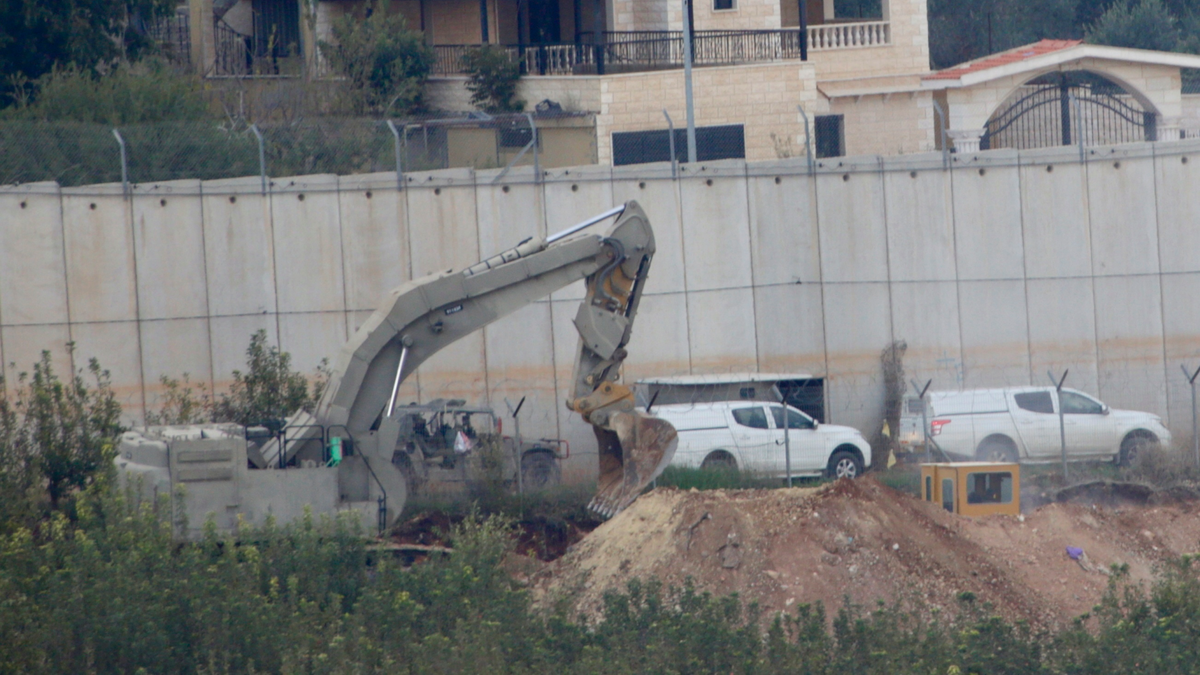 Israeli military digger works on the border with Lebanon in the northern Israeli town of Metula, Tuesday, Dec. 4, 2018. The Israeli military launched an operation on Tuesday to "expose and thwart" tunnels built by the Hezbollah militant group it says stretch from Lebanon into northern Israel. (AP Photo/Ariel Schalit)